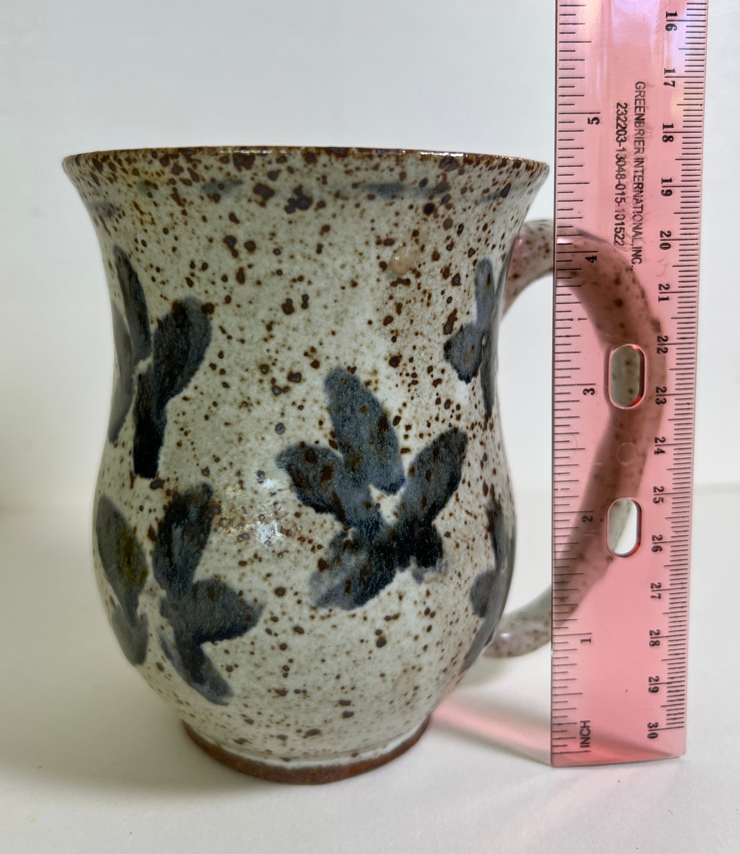 White Speckled Mug with Blue Floral Accents