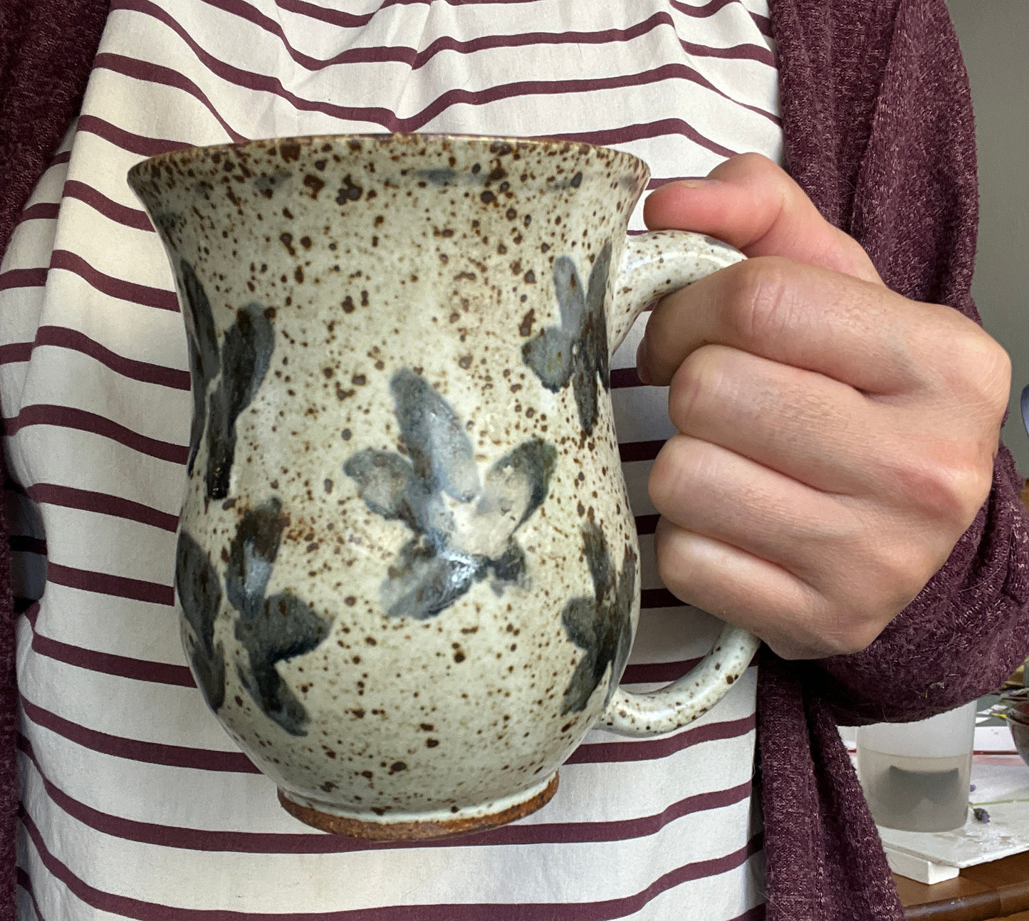 White Speckled Mug with Blue Floral Accents